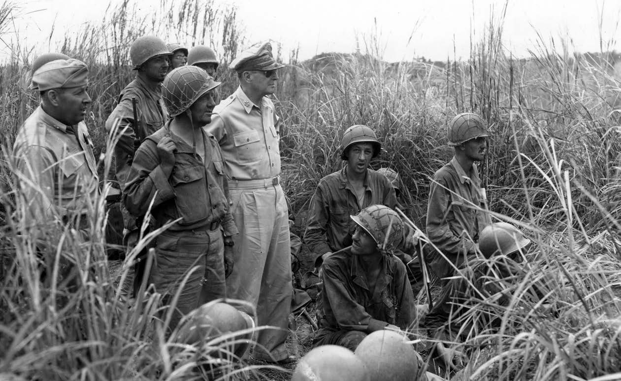 General of the Army Douglas MacArthur, with Soldiers from 37th Infantry Division, watches shelling of Japanese-occupied houses from artillery observation post in Fort Stotsenburg, Luzon, Philippine Islands, January 29, 1945 (U.S. Army Signal Corps/Gae Faillace)